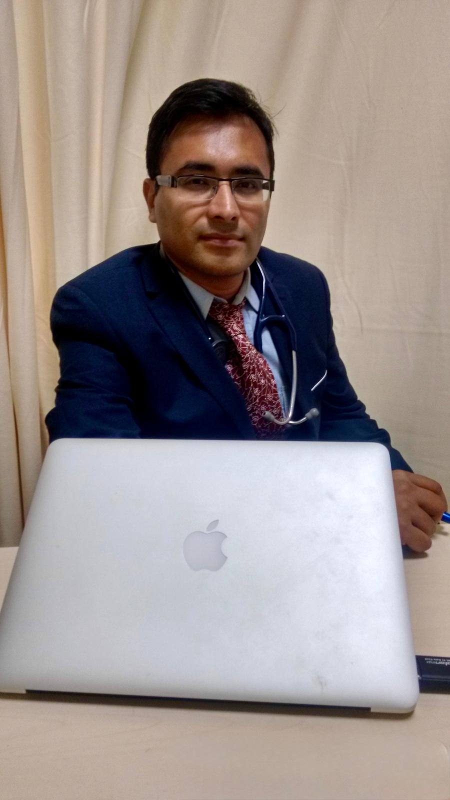 Dr. Anirban Chakraborty working at his clinical desk